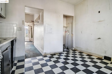 Kitchen with electric panel, light countertops, and black dishwasher