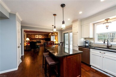The gleaming hardwood floors lead into the kitchen