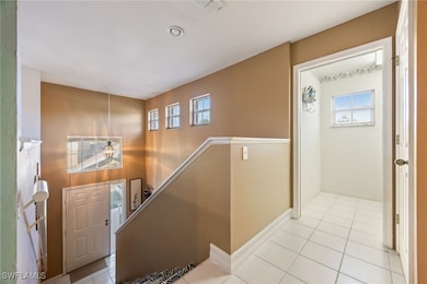 Tiled entryway featuring healthy amount of natural