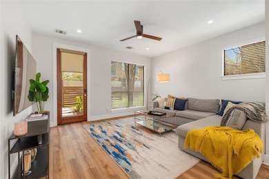 Living room with recessed lighting, ceiling fan, 