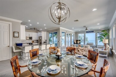 Dining space with crown molding, ceiling fan with