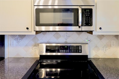 Kitchen featuring stainless steel appliances, dec