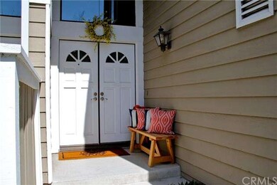 Welcoming double door entry with a clerestory wind