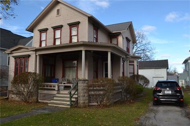 Classic covered front porch with stone pillars