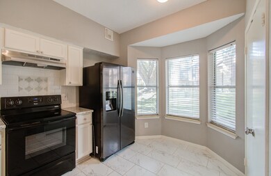 This is a well-lit, modern kitchen featuring stain