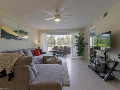 Updated Tiled living area featuring a ceiling fan 