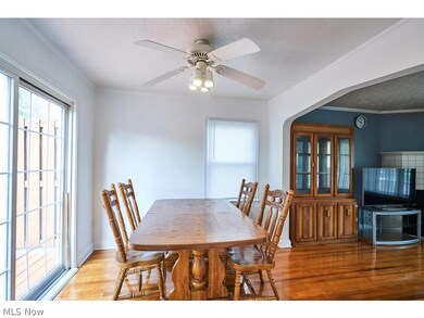 Dining room with crown molding, ceiling fan, and hardwood / wood-style floors