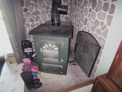 Coal wood stove in kitchen with hearth.