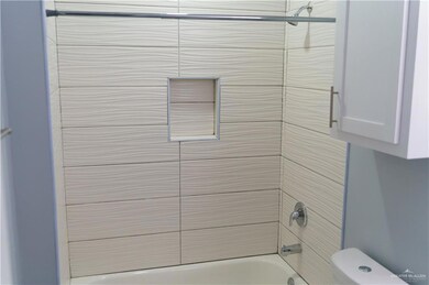 Bathroom featuring washtub / shower combination and toilet