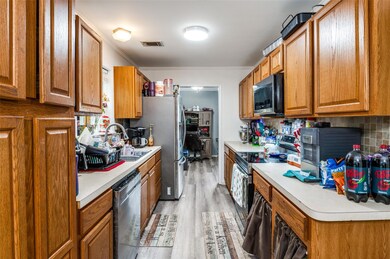 Kitchen featuring light hardwood / wood-style floors, tasteful backsplash, stainless steel appliances, crown molding, and sink