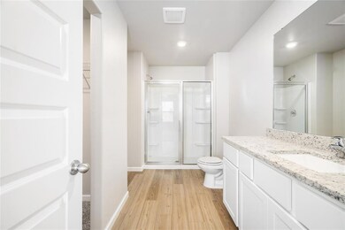 Step into your modern ensuite with granite countertops, dual vanities, and a glass-enclosed walk-in shower—both functional and elegant.