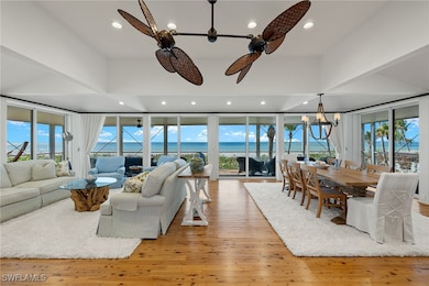 Living room with ceiling fan with notable chandeli