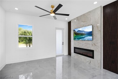 Unfurnished living room featuring a tile fireplace