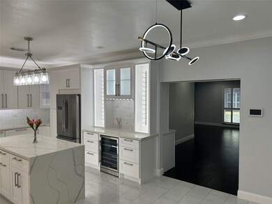 Enjoy a beautiful view of the kitchen featuring quartz countertops and plenty of bright lighting. Features soft-close drawers throughout.