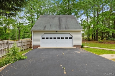 Detached garage featuring fence