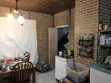 Kitchen downstairs unit, tin ceiling