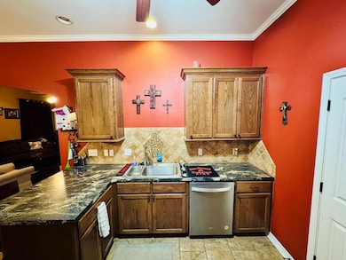 Kitchen with tasteful backsplash, sink, stainless 
