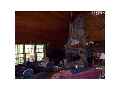 dramatic great room with stone fireplace