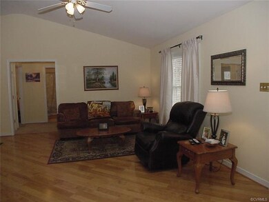 Living room area w ceiling fan