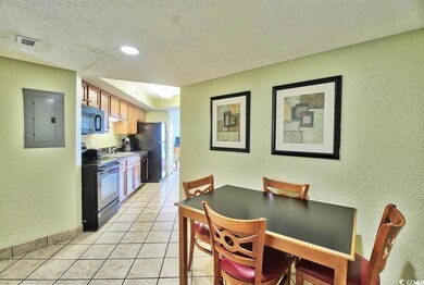 Dining area with a textured wall, visible vents, l