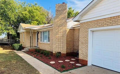 View of home's exterior featuring brick siding and a chimney