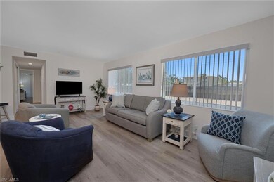 Living area with light wood-style flooring and vis