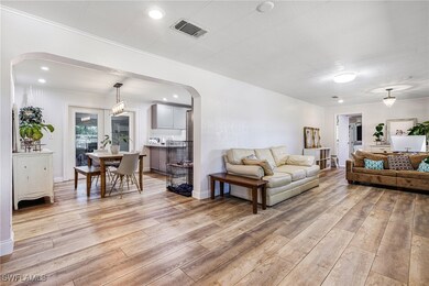 Living area with arched walkways, visible vents, l