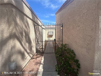 View of home's exterior featuring a gate and stucc