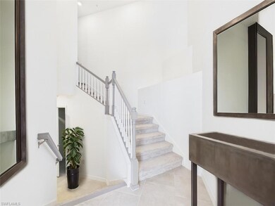 Stairs with a high ceiling and tile patterned floo