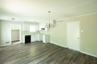 Unfurnished living room featuring sink, a notable 