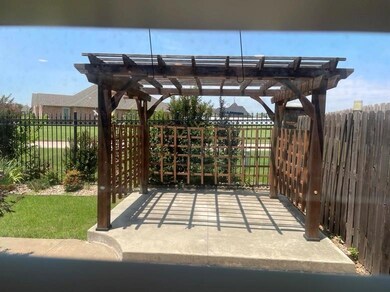 View of back yard with a pergola.