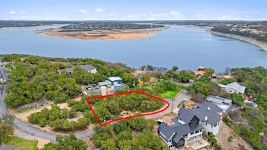 Aerial perspective of suburban area featuring property parcel outlined and a nearby body of water