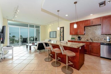 Kitchen featuring tasteful backsplash, track lighting, a wall of windows, dishwasher, and a sink