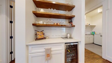 Butler pantry with beverage cooler and access to p