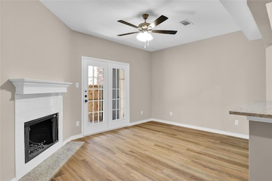 Unfurnished living room featuring a fireplace, lig