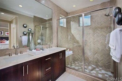 Master bath is equipped with his & her sinks, larg