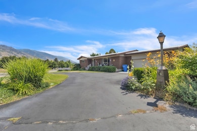 View of asphalt driveway with street lights and a mountain view