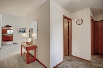 Nice wide hallway leads to living room and kitchen