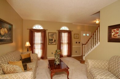 Living room has beautiful palladium windows.