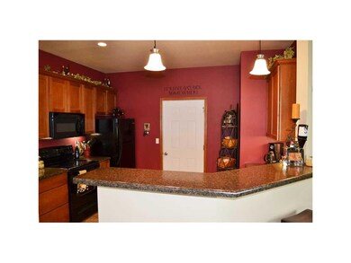 Kitchen. Black appliances, pantry, breakfast bar