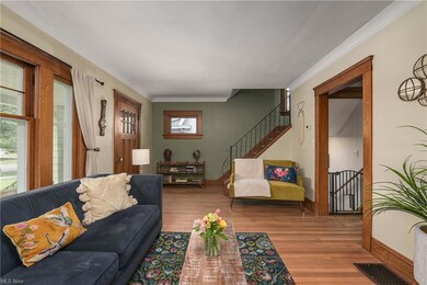 Living room looking toward the stairs to the second floor and side door (right).