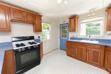 Open kitchen, back door leads to fenced in yard.