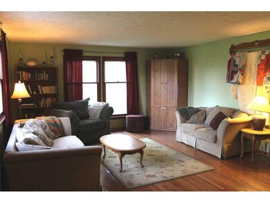 Family Room. The spacious family room greets you upon entry.  Notice the beautiful hardwoods throughout and the tall windows.