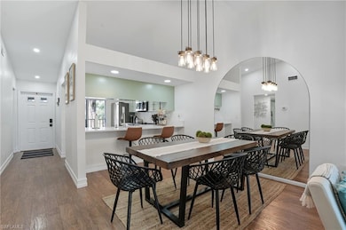 Stylish dining area with vaulted ceilings, modern lighting, and open flow into the kitchen and living room.