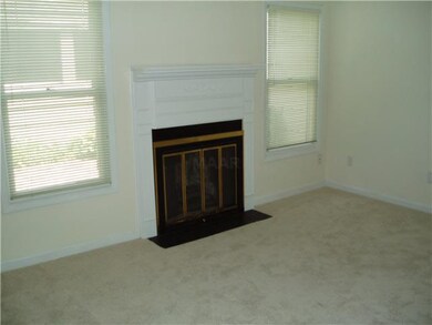 The living room has a woodburning fireplace.