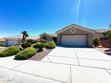 Ranch-style house featuring stucco siding, an atta