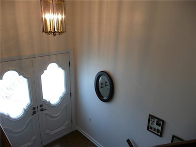 Open entry foyer with double doors
