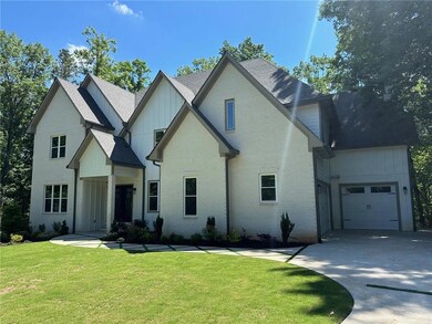 View of front facade with a garage and a front law
