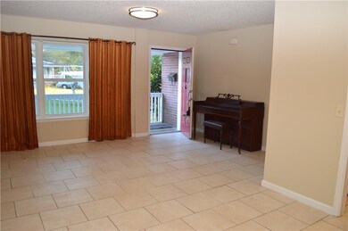 Living Room with tile floors and large windows in