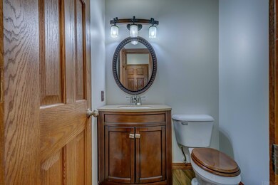 The main floor half bath is short hall between the